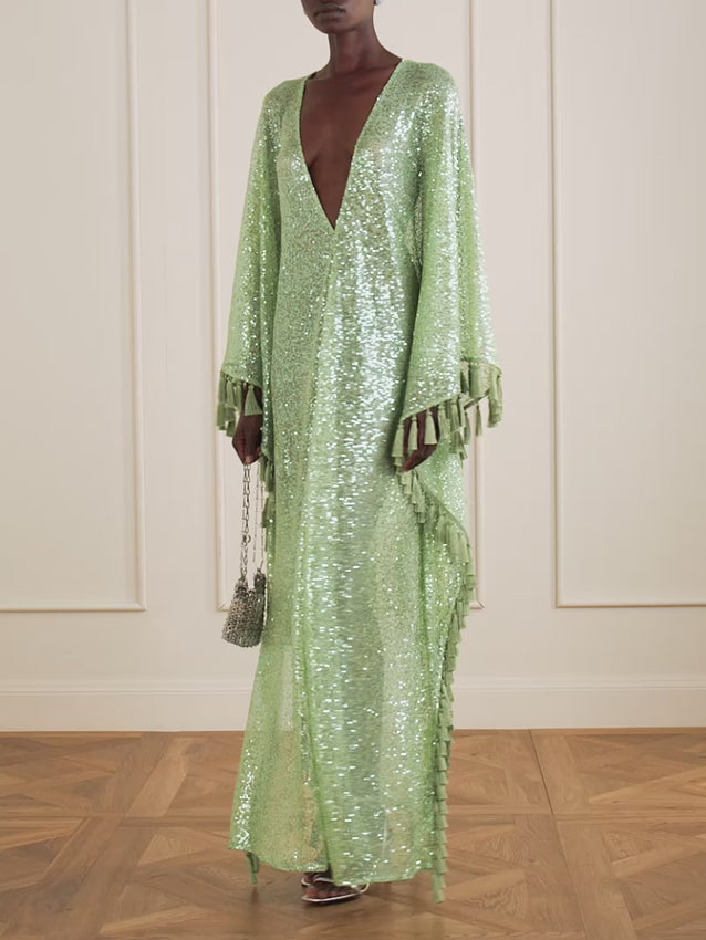 Elevate your evening with this stunning sequined fringed gown by Taller Marmo. Crafted for those who dare to shine, this dress features intricate sequin detailing and dramatic fringe that moves with every step. Perfect for galas, celebrations, and unforgettable nights out. The luxurious design combines glamour with sophisticated movement, ensuring you'll be the center of attention.