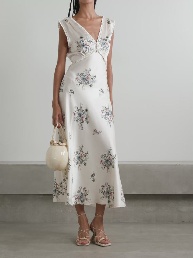 Effortless elegance meets romantic charm in the Tahlia midi dress. Crafted from luxurious silk-charmeuse, this piece features a delicate floral print that captures understated sophistication. Intricate lace trimming adds a refined touch, while the midi length offers versatile styling for both day and evening occasions. The fluid fabric drapes beautifully, creating a flattering silhouette that moves with grace. Perfect for those who appreciate timeless design with modern sensibility.