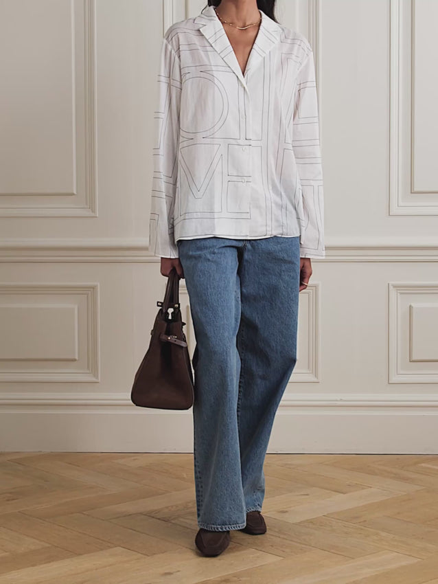 Inspired by traditional pajamas yet effortlessly wearable beyond the bedroom, this shirt blends relaxed elegance with everyday versatility. Crafted from a luxurious organic cotton and silk-blend, it features the brand's signature monogram embroidered as a subtle geometric pattern that reveals itself on closer inspection. Cut for a relaxed, comfortable fit with a high rise and elasticated waist, this lightweight piece pairs perfectly with the matching pants to complete the set. 