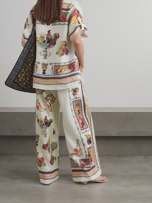 Discover the essence of Italian countryside charm with ALÉMAIS' Mercado printed linen wide-leg pants from the Fall '25 collection. Crafted from breathable linen, these pants feature a comfortable elasticated waist and flowing wide legs adorned with vibrant fresh market produce prints. Perfect for warm-weather adventures, pair them with a bikini top and the matching shirt for an effortlessly romantic, resort-ready look that captures the spirit of wanderlust and timeless elegance.