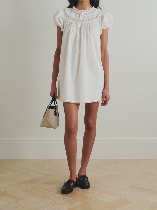 The Daphne Mini Dress in Salt is the perfect warm-weather essential. Crafted from soft cotton-voile, this sweet piece features delicate pintucking along the neckline and charming lace and grosgrain trim details. Pair it effortlessly with sandals or ballet flats for an understated, elegant look that works from day to evening.
