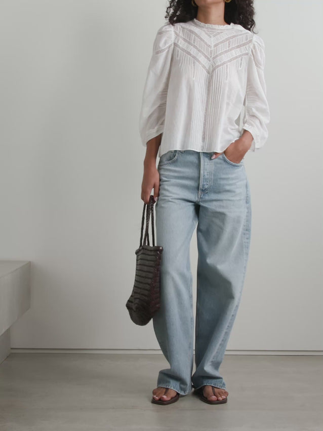 Effortless elegance meets sustainable style with the Adelphine Top in Salt. Crafted from breathable organic cotton-voile, this blouse features delicate pintucking throughout for refined texture and movement. Intricate crochet trim adorns the neckline and cuffs, adding a touch of artisanal charm. Perfect for layering or wearing solo, this versatile piece transitions seamlessly from day to evening. The soft, neutral salt tone pairs beautifully with any wardrobe staple.