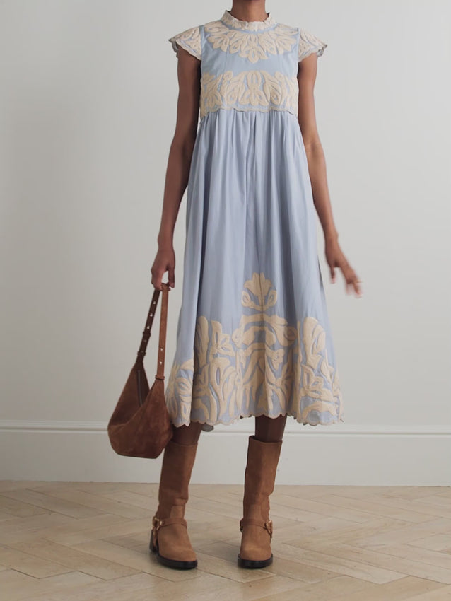 The Alexandra midi dress combines timeless elegance with delicate craftsmanship. Crafted from soft cotton, this piece features intricate embroidery and a charming scalloped hemline that adds feminine detail. The midi length offers versatile styling for both casual and dressed-up occasions. Perfect for warm weather wear, this dress moves beautifully and feels comfortable throughout the day. A wardrobe essential that transitions effortlessly from day to evening.