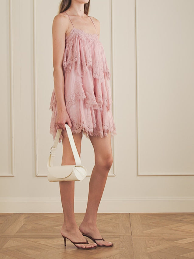 Embrace ethereal elegance with the Ophelia dress, featuring a dreamy scalloped, tiered silhouette adorned with delicate lace detailing. This chiffon piece drapes beautifully on slim, cross-back straps for a flattering silhouette. Perfect for creating a subtle bohemian aesthetic—pair with pendant necklaces and boots to complete the look. A versatile piece that transitions effortlessly from day to evening occasions.