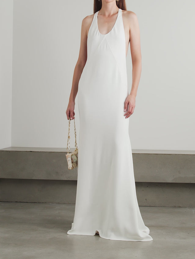 Jacquemus' Marcel paneled crepe maxi dress offers a refined silhouette with its sleek racerback design and expertly crafted panels. Made from smooth crepe fabric, it gently contours the body and effortlessly falls to a floor-length hem, creating a harmonious blend of sporty elegance and subtle glamour. Ideal for pairing with minimalist sandals and delicate jewelry, this dress epitomizes modern sophistication with a thoughtful balance of structure and fluidity.