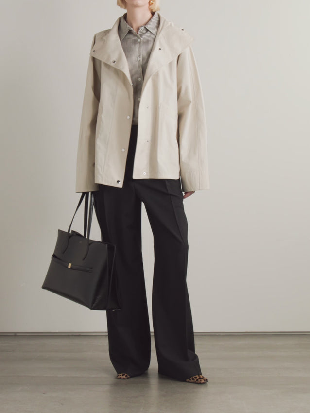 Designed with TOTEME's signature minimalist philosophy, this organic cotton-blend jacket balances refined simplicity with practical functionality. The relaxed fit and dropped shoulders create an easy, contemporary silhouette, while the structured high stand collar provides subtle polish. Organic cotton paired with recycled polyamide delivers a mid-weight fabric with natural breathability. 