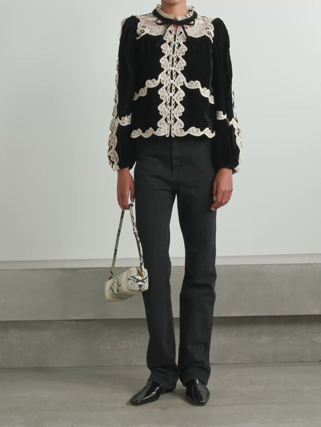 Elevate your wardrobe with the Medina blouse by Sea, where sumptuous velvet meets intricate guipure lace detailing. This sophisticated piece features delicate lace trim that frames the neckline and cuffs, adding an air of refined elegance to any ensemble. The soft velvet fabric drapes beautifully against the skin, offering both comfort and a luxurious feel. 