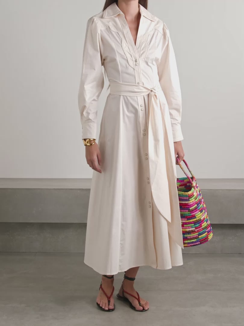 Johanna Ortiz’s Vela De Cruz midi shirt dress elevates a timeless silhouette with expertly tailored cotton-blend poplin. The finely pleated fabric adds refined texture, while the self-tie belt accentuates the waist for a flattering shape. Carefully selected tonal and silver-tone buttons enhance the sophisticated appeal, making this dress a versatile choice for polished, confident dressing.