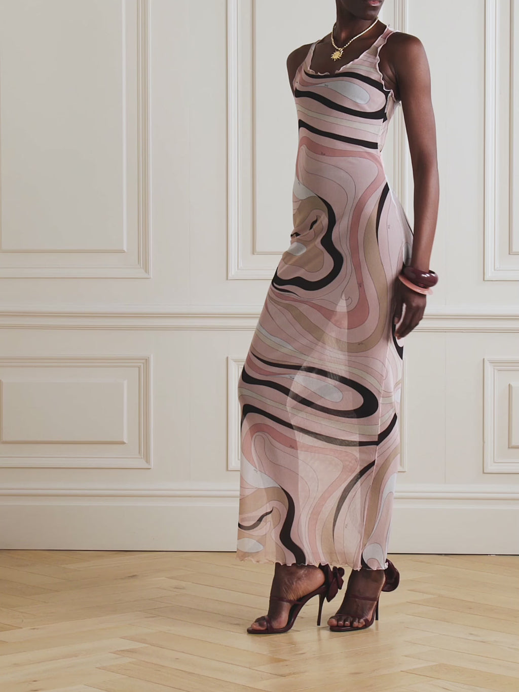 The Marmo Tulle Dress by PUCCI features sheer mesh fabric accented with delicate ruffled trims, showcasing the iconic marbled 'Marmo' motif from 1968. Designed for a body-hugging silhouette, it offers versatility—wear it over tonal underlayers for a chic look or as a stylish coverup for beach and boat outings.