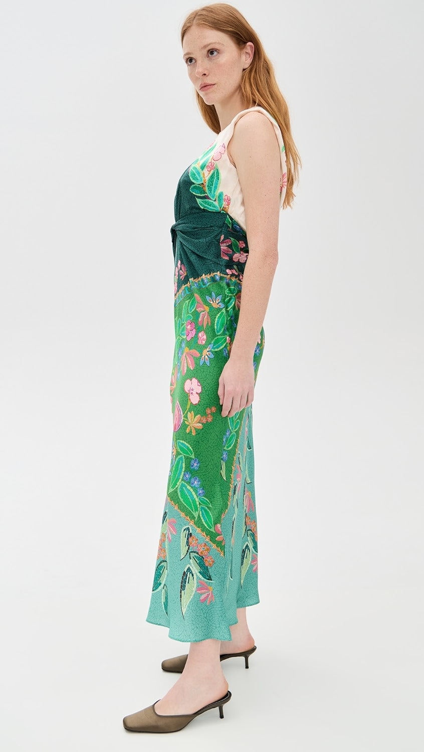 Crafted from lightweight silk charmeuse, the Gwen Dress by Saloni features a delicate floral print that enhances its elegant maxi silhouette. Expertly designed with a twist detail at the waist, it flatters the figure while a subtle split at the back, secured by hook-and-eye closures, offers ease of movement. The dress is completed with a refined crew neck and a hidden back zip for a smooth, tailored finish, making it an exquisite choice for sophisticated occasions.