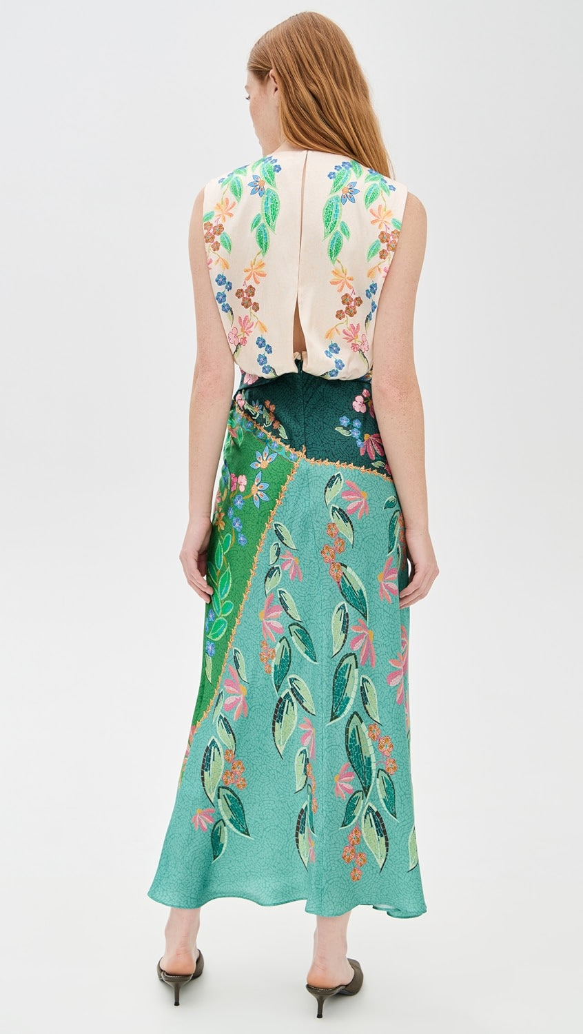 Crafted from lightweight silk charmeuse, the Gwen Dress by Saloni features a delicate floral print that enhances its elegant maxi silhouette. Expertly designed with a twist detail at the waist, it flatters the figure while a subtle split at the back, secured by hook-and-eye closures, offers ease of movement. The dress is completed with a refined crew neck and a hidden back zip for a smooth, tailored finish, making it an exquisite choice for sophisticated occasions.