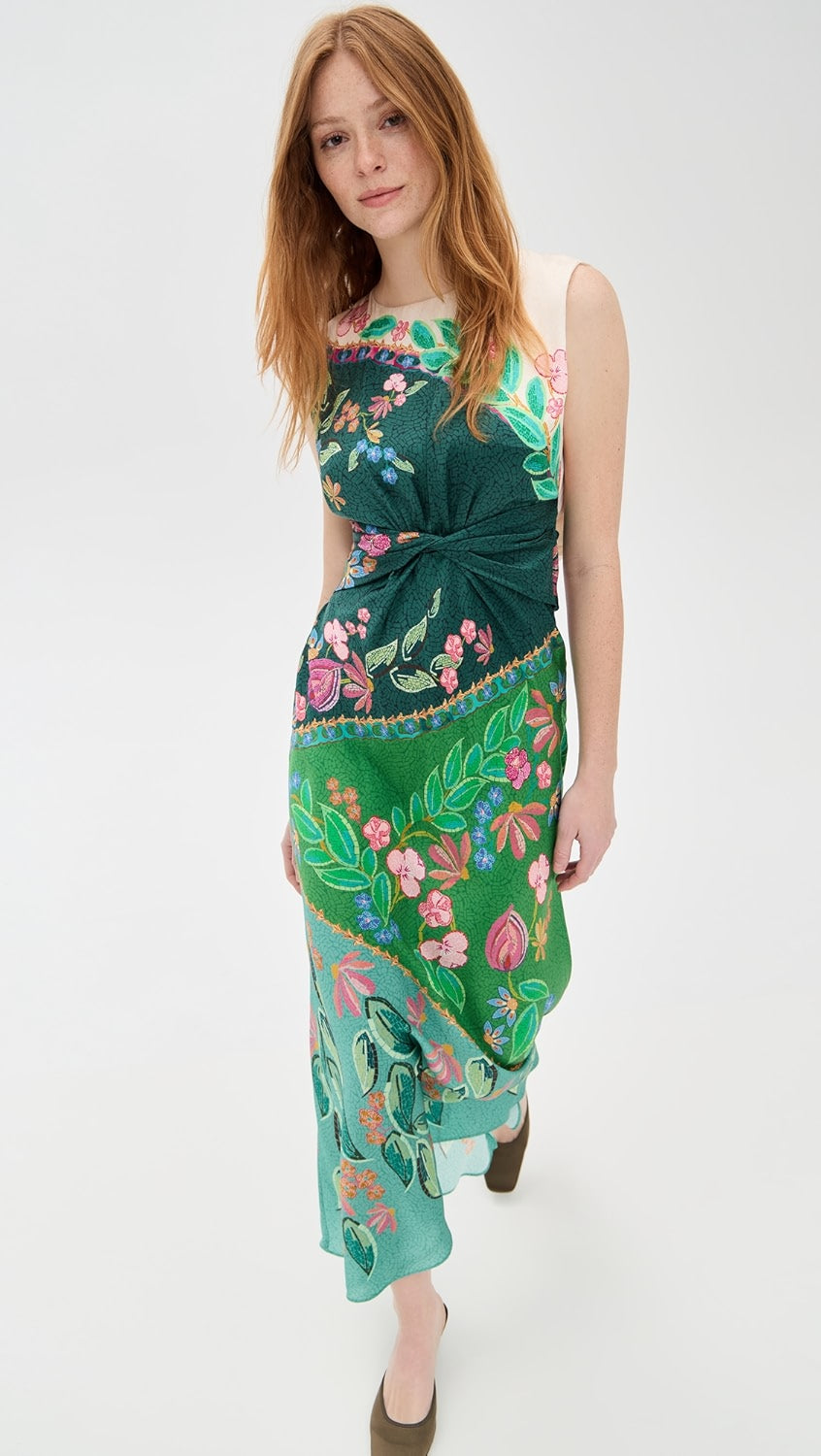 Crafted from lightweight silk charmeuse, the Gwen Dress by Saloni features a delicate floral print that enhances its elegant maxi silhouette. Expertly designed with a twist detail at the waist, it flatters the figure while a subtle split at the back, secured by hook-and-eye closures, offers ease of movement. The dress is completed with a refined crew neck and a hidden back zip for a smooth, tailored finish, making it an exquisite choice for sophisticated occasions.